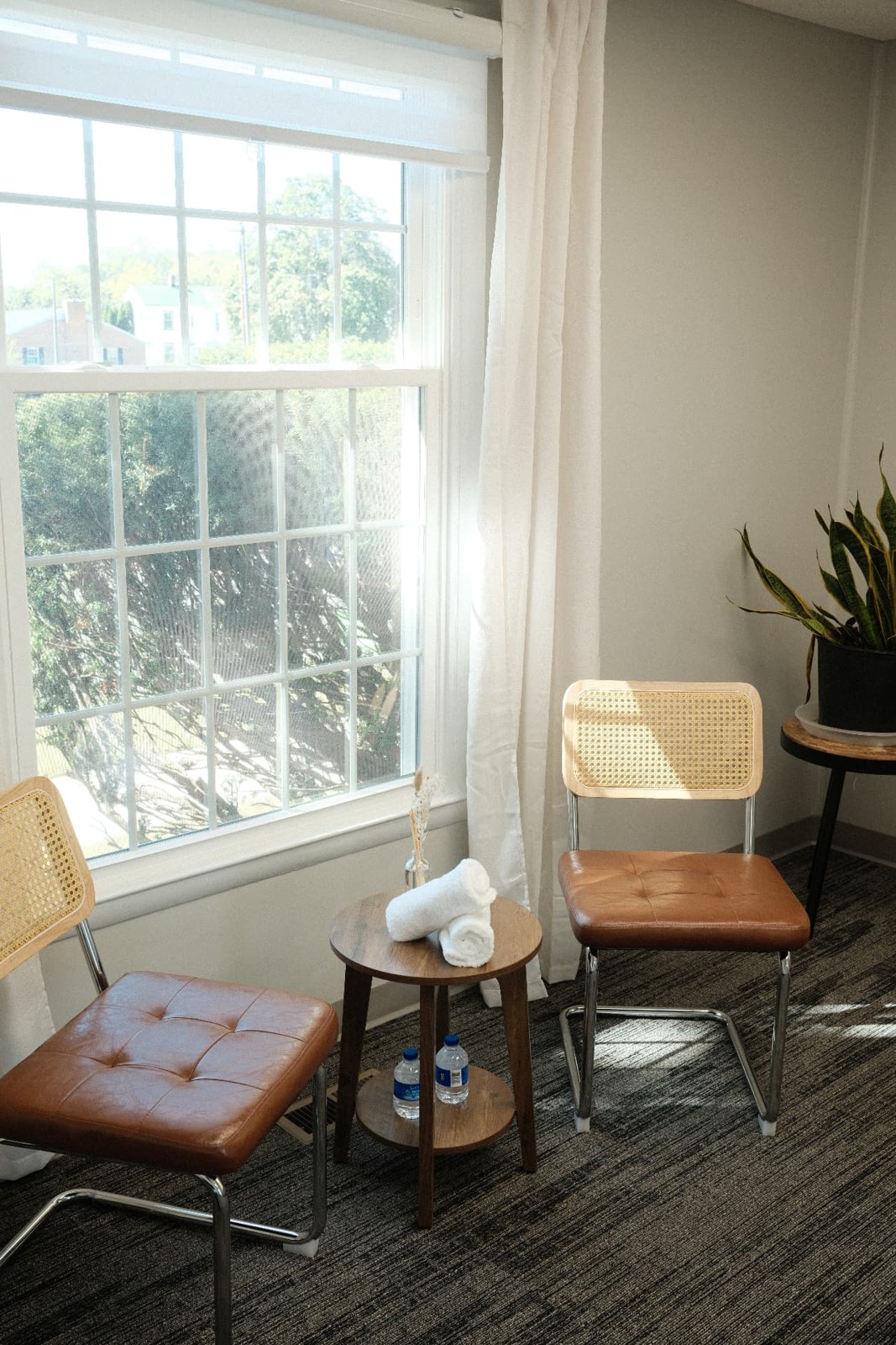 Sunlight falling across the rattan chairs in our studio