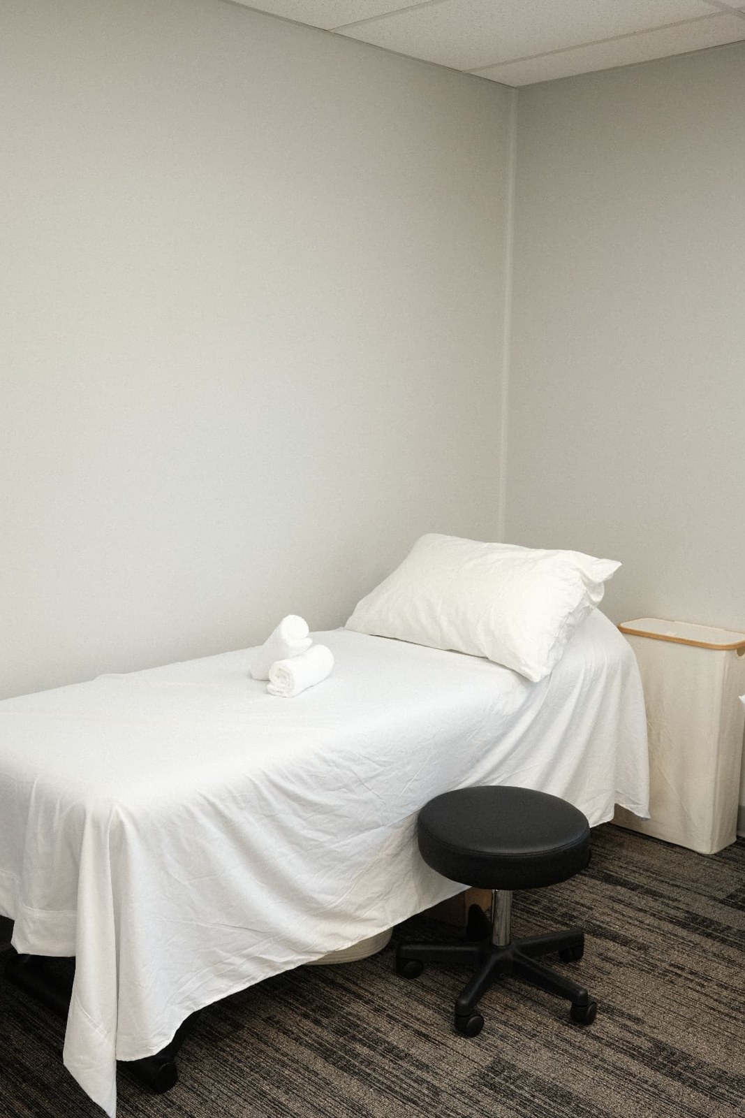 Fresh white linens on the treatment table in our private studio